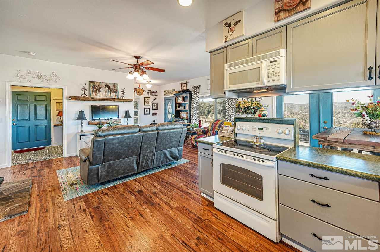 3650 Palisade Road Reno, NV 89521 - Photo 25 of 25 a kitchen with stainless steel appliances granite countertop a stove cabinets and wooden floor