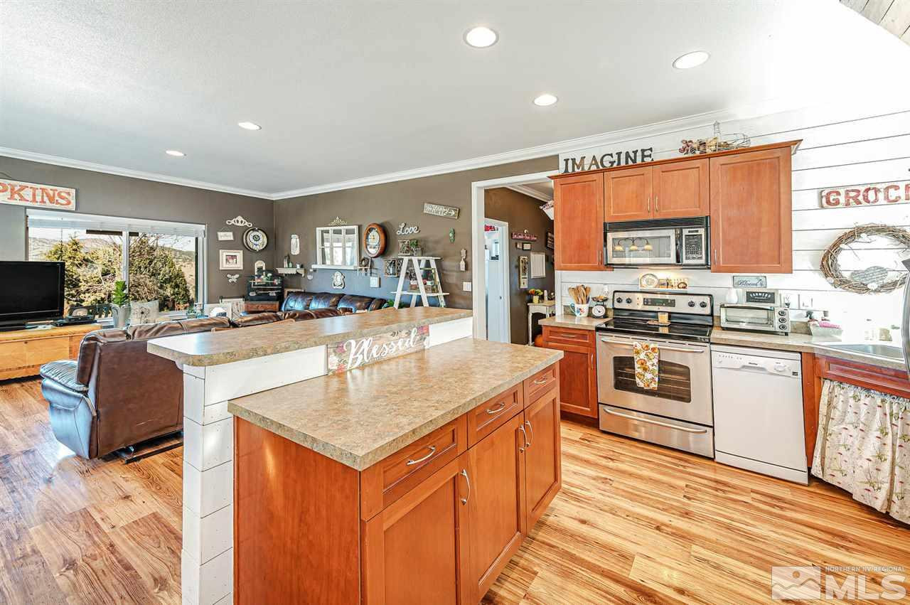 3650 Palisade Road Reno, NV 89521 - Photo 10 of 25 a kitchen with stainless steel appliances granite countertop a kitchen island a stove and a sink