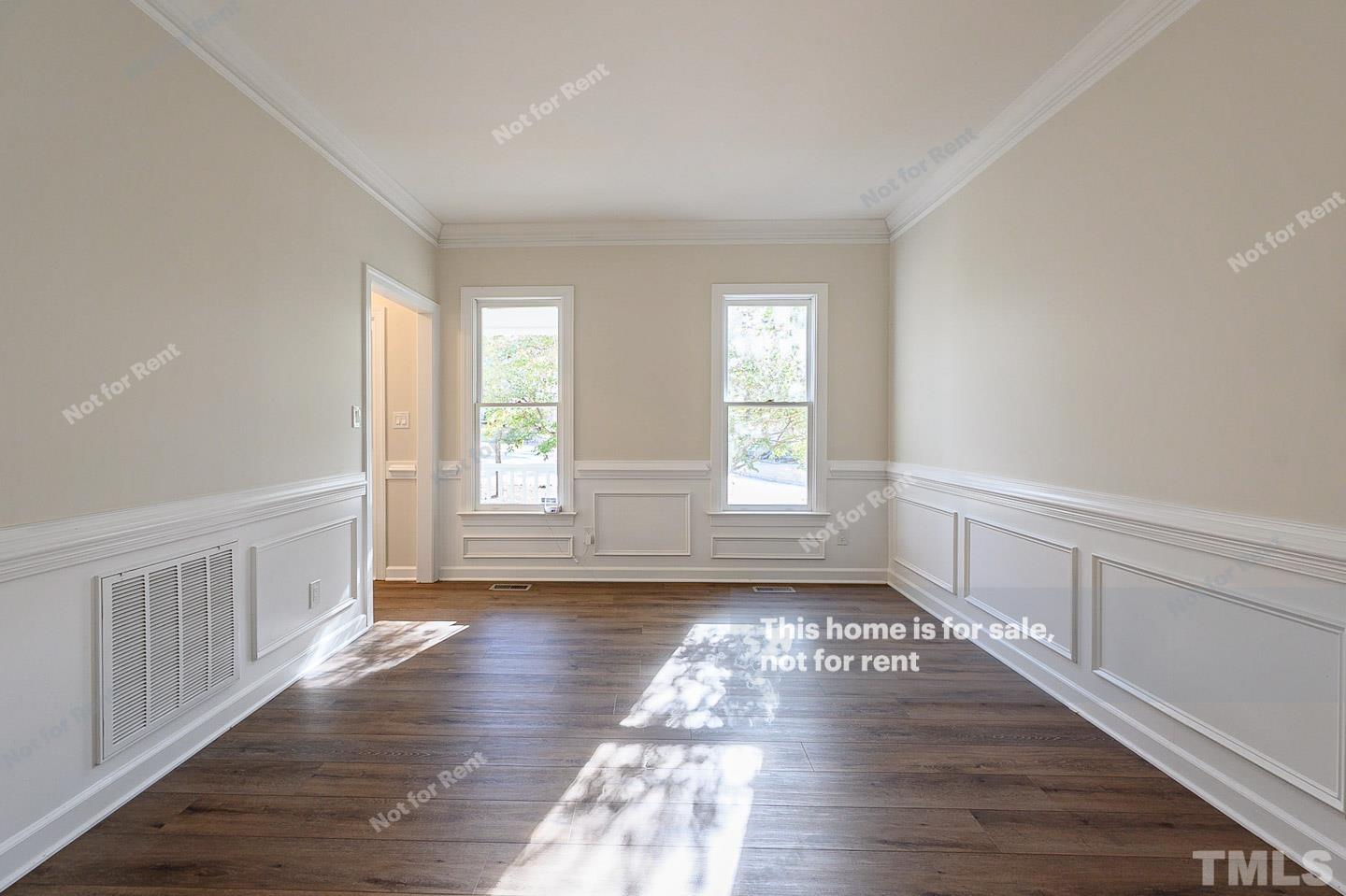 203 Parkgate Drive Cary, NC 27519 - Photo 19 of 31 a view of an empty room with wooden floor and window
