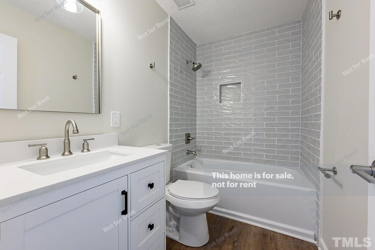 203 Parkgate Drive Cary, NC 27519 - Photo 27 of 31 a bathroom with a sink a toilet and shower