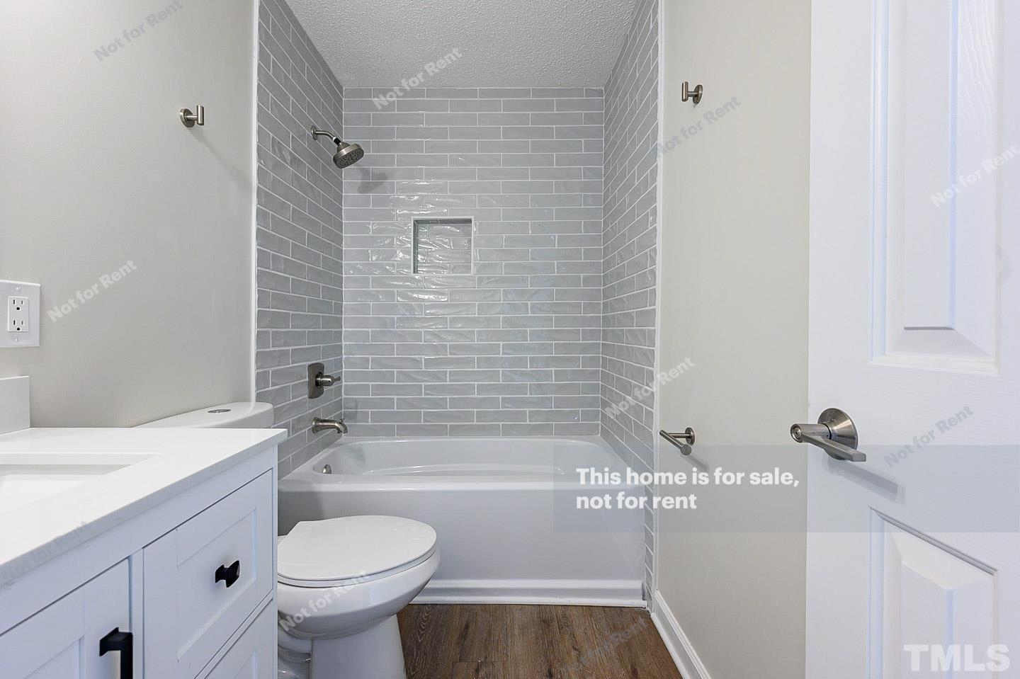 203 Parkgate Drive Cary, NC 27519 - Photo 28 of 31 a bathroom with a sink a toilet and shower