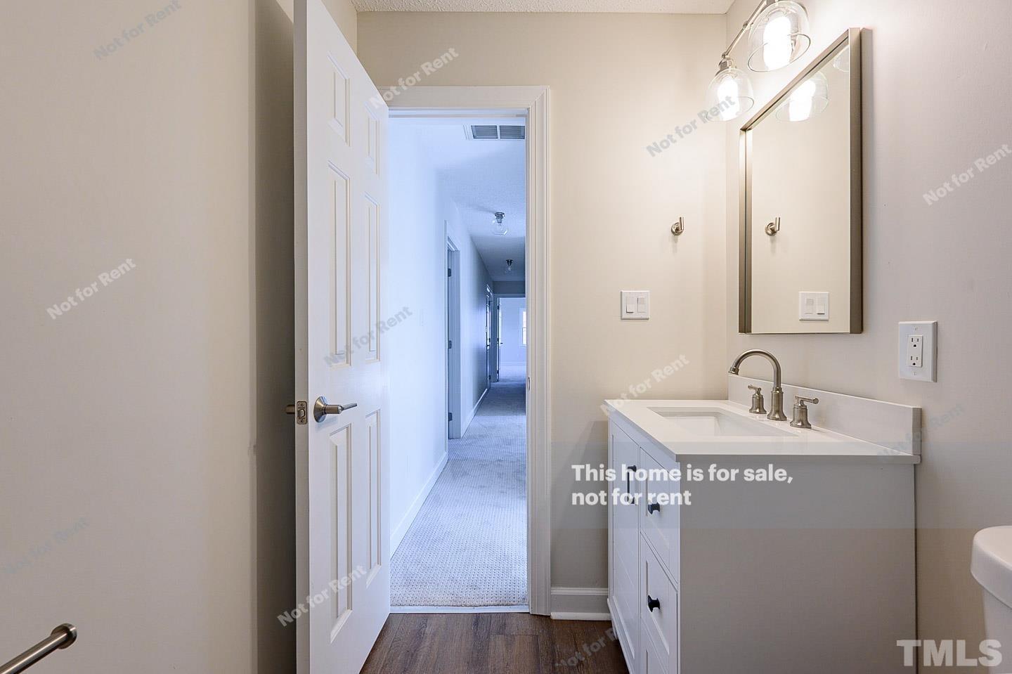 203 Parkgate Drive Cary, NC 27519 - Photo 29 of 31 a bathroom with a sink and a mirror