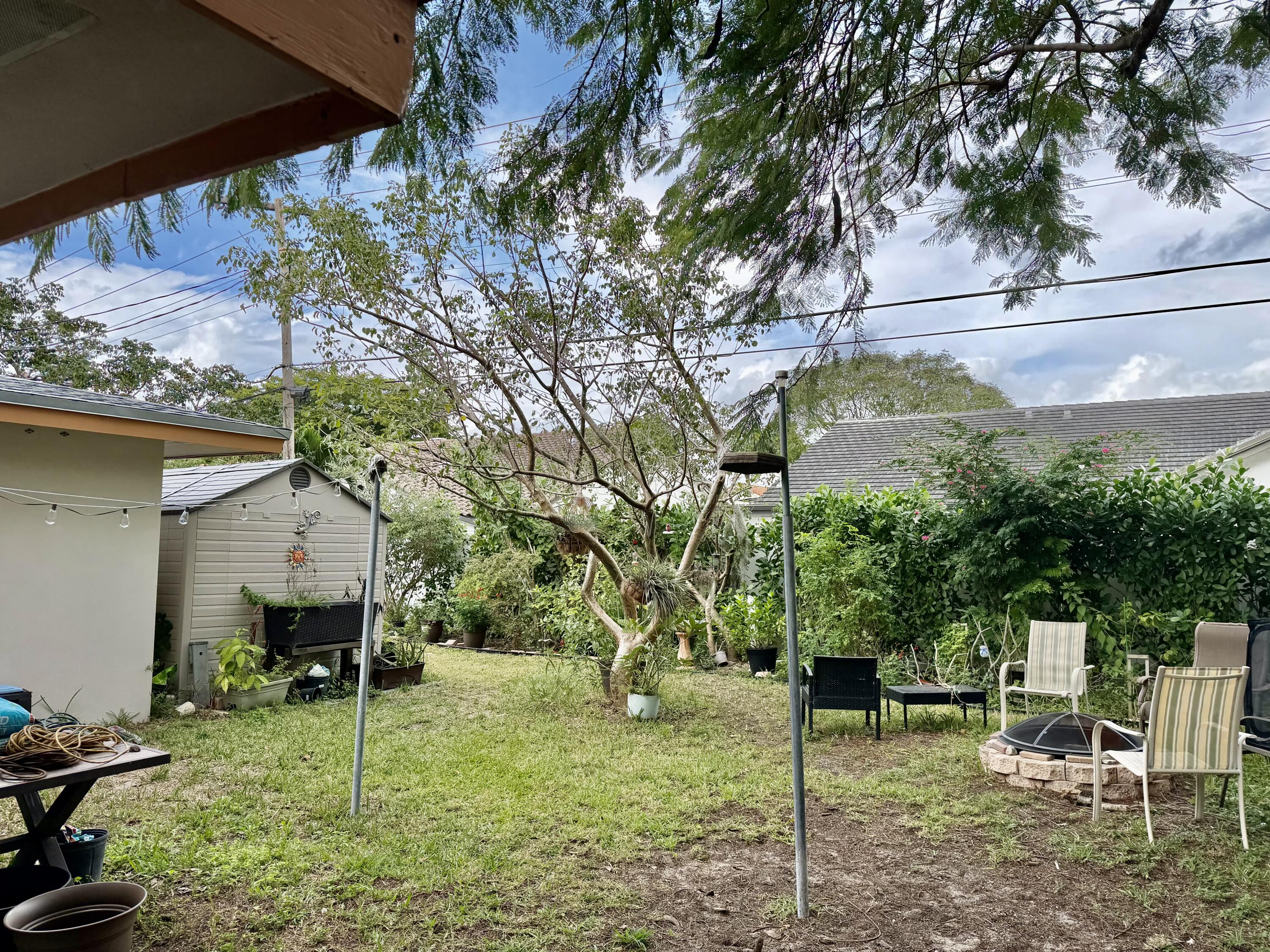 1371 Southwest 4th Street Boca Raton, FL 33486 - Photo 17 of 19 a backyard of a house with table and chairs