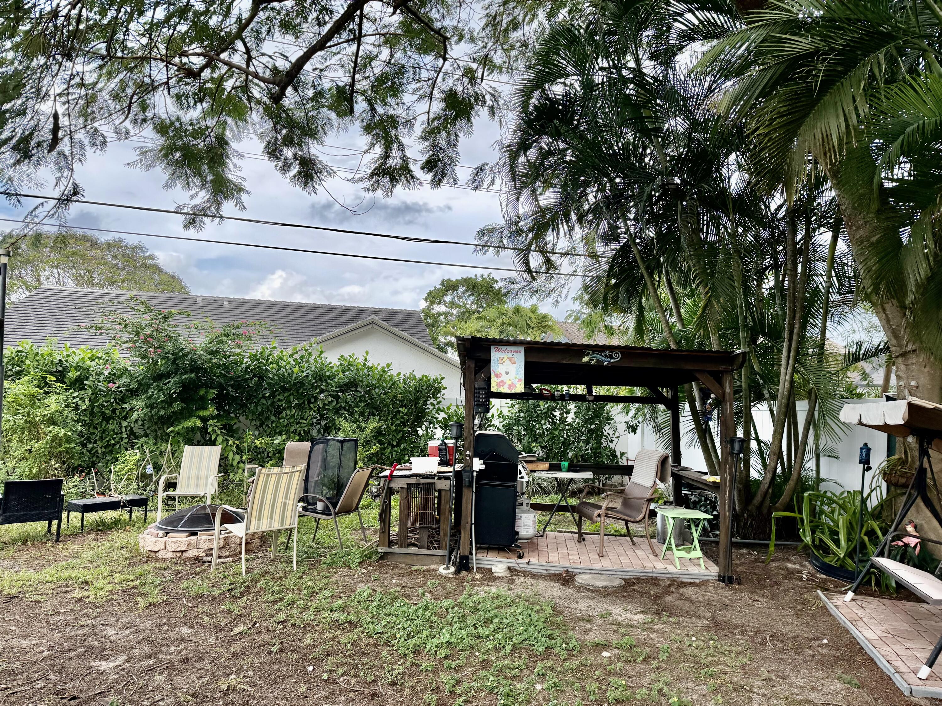 1371 Southwest 4th Street Boca Raton, FL 33486 - Photo 18 of 19 a view of a chairs and table in a patio