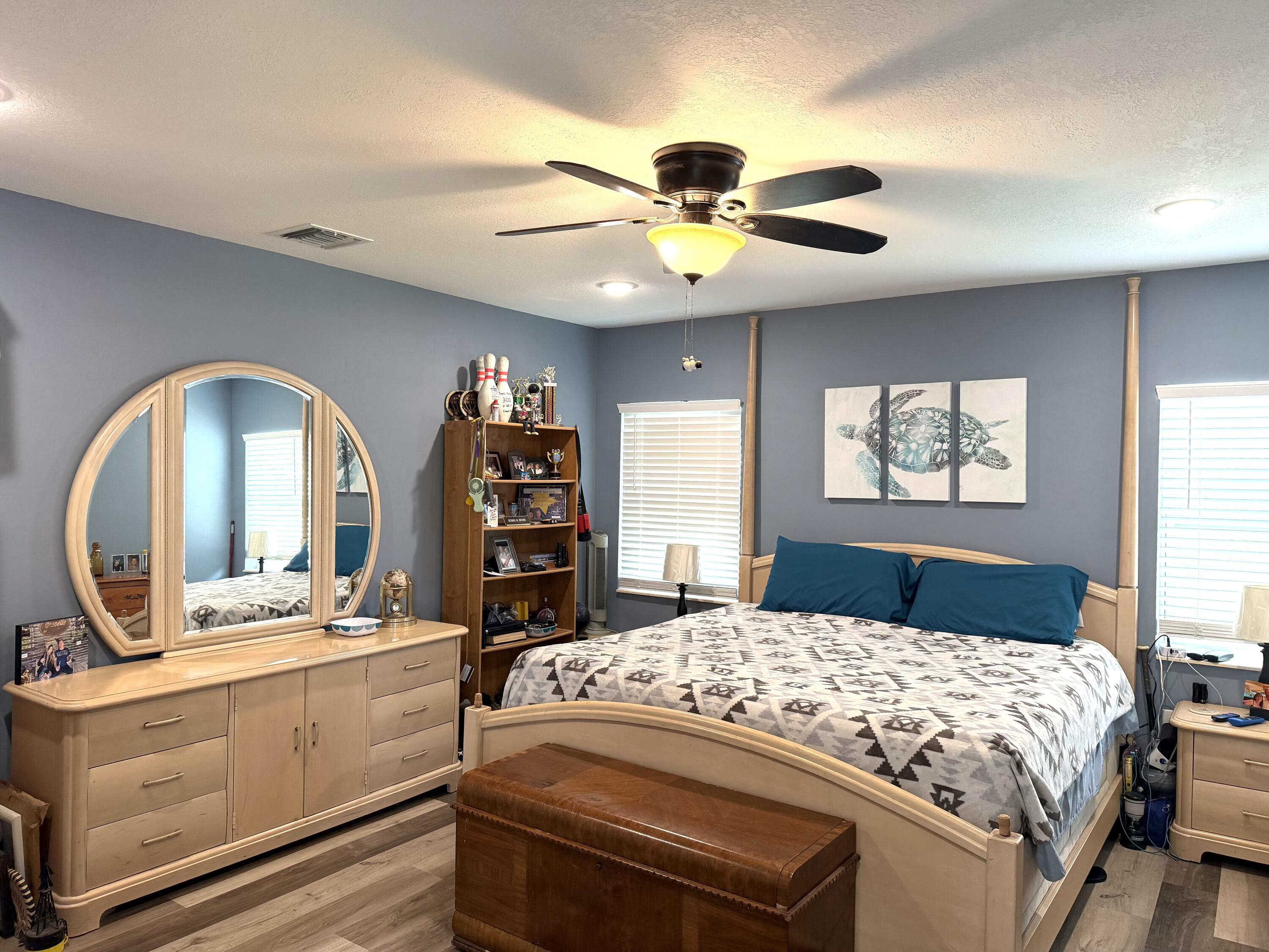 1371 Southwest 4th Street Boca Raton, FL 33486 - Photo 6 of 19 a bedroom with a bed a dresser and a large mirror