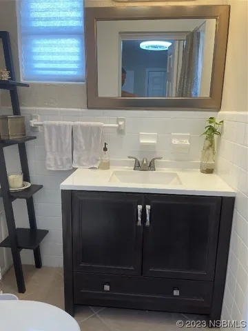 a bathroom with a sink vanity and mirror