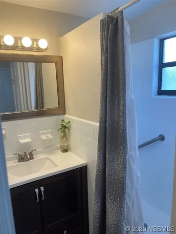 a bedroom with a bed a mirror and a window