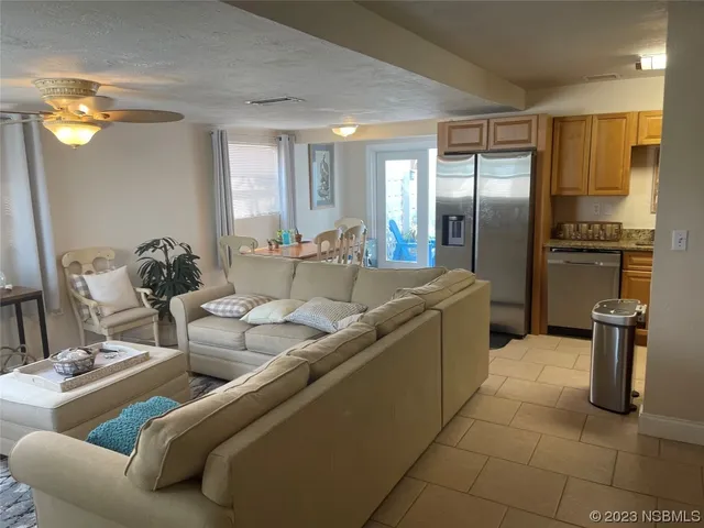 a kitchen with stainless steel appliances granite countertop a sink and a refrigerator