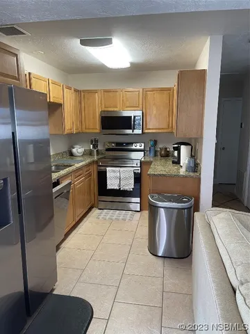 a kitchen with a stove cabinets and stainless steel appliances