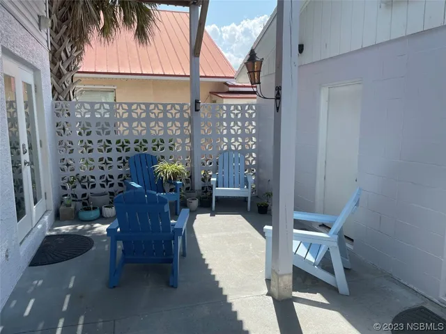 a balcony with table and chairs