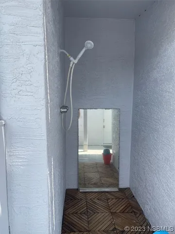 a view of a hallway view with wooden floor and staircase
