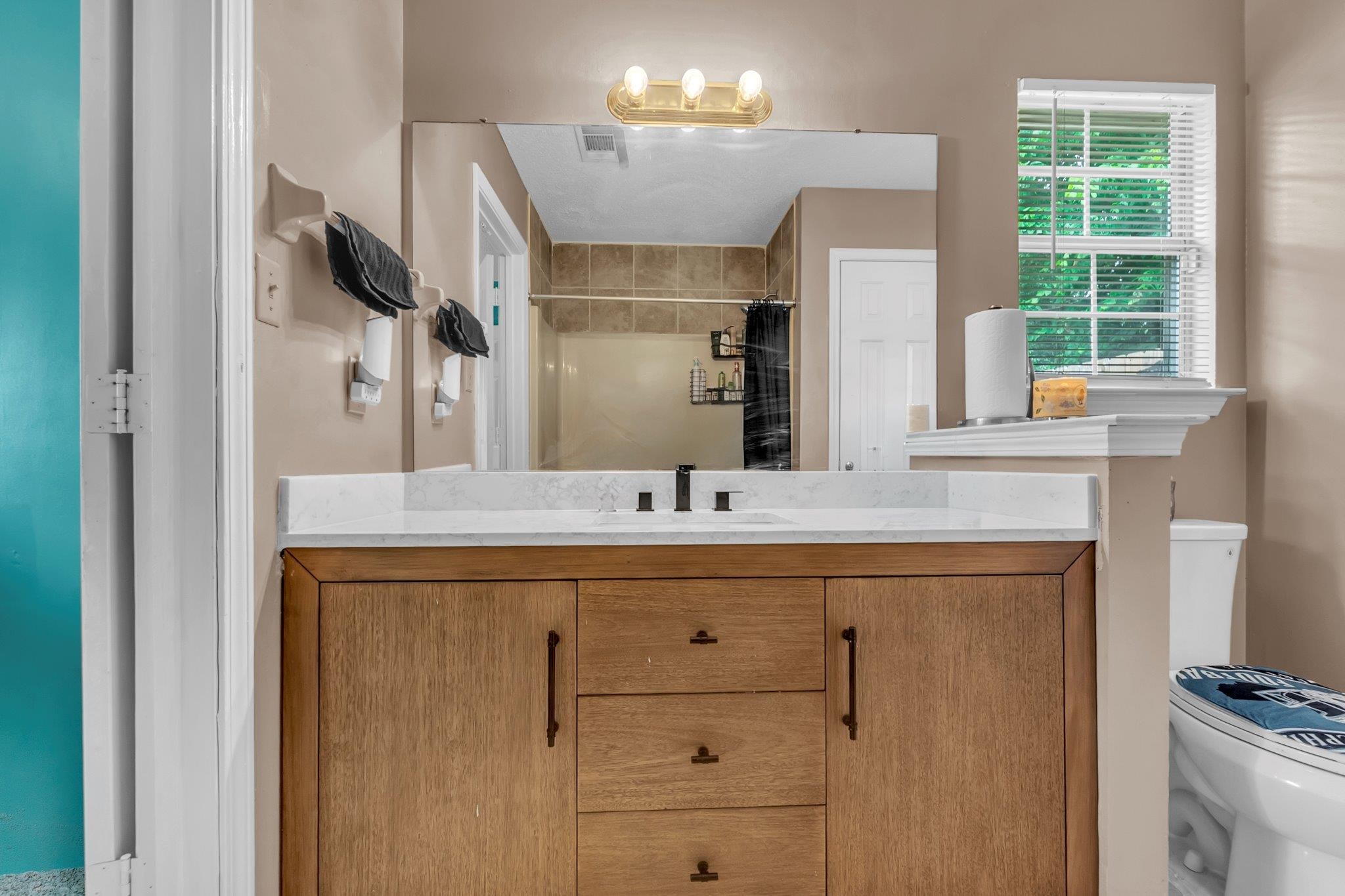 5930 Chadwell Road Millington, TN 38053 - Photo 15 of 17 Bathroom featuring a wood-finish vanity with a light-colored countertop and a rectangular sink