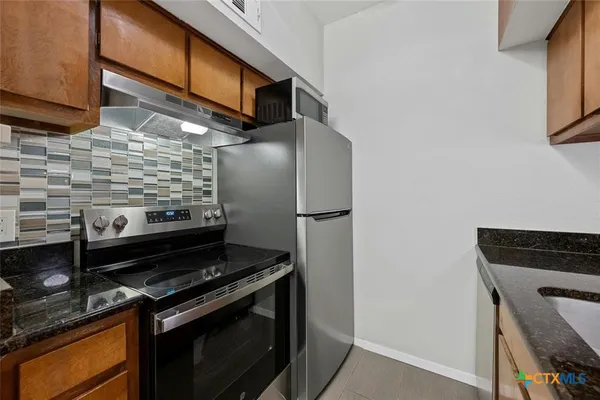 a kitchen with a stove and a microwave