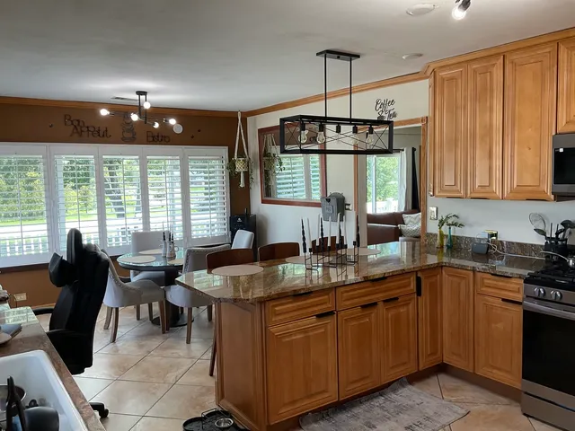 a kitchen with sink stove and cabinets