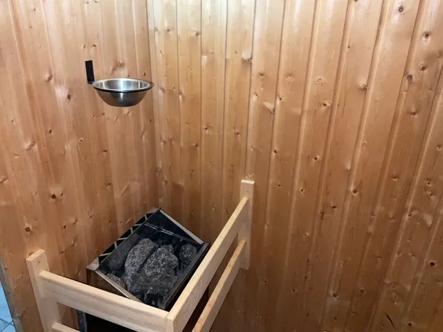 a view of a door and chair in wooden floor
