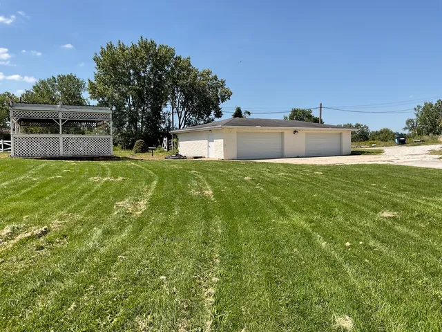 a front view of a house with a garden and yard
