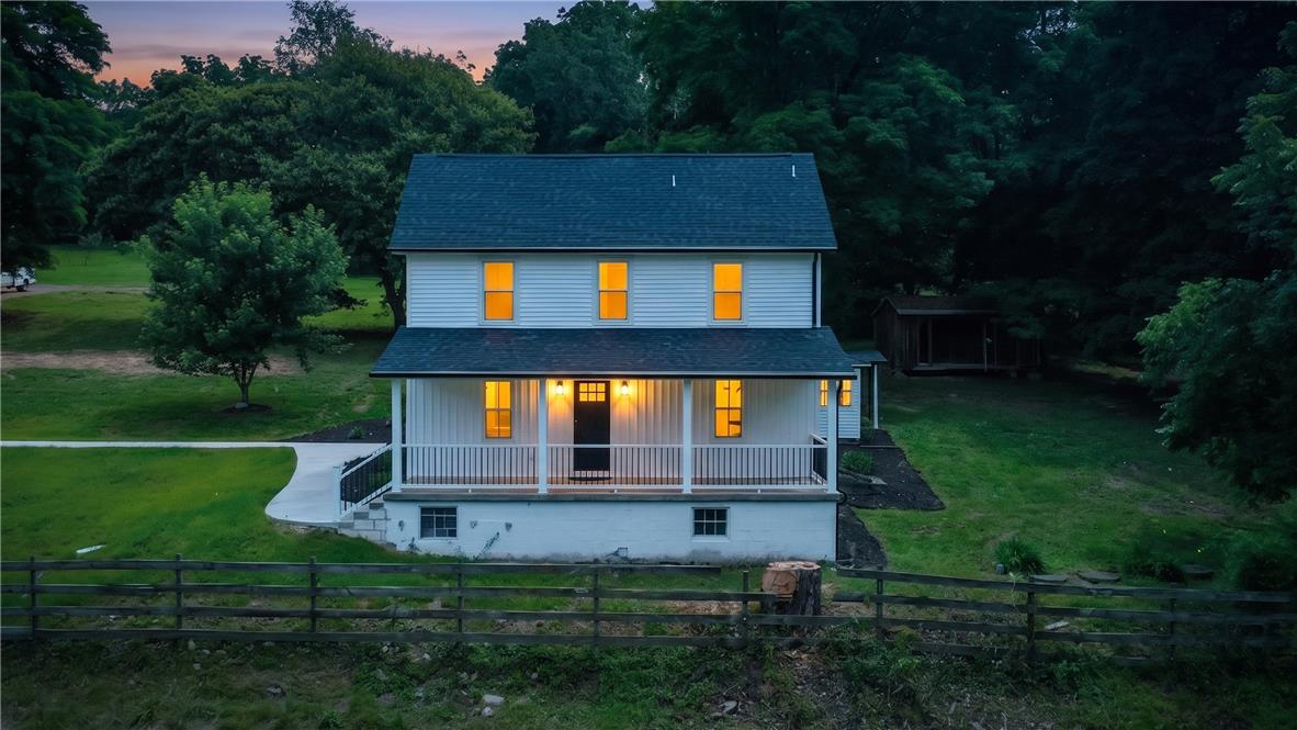 72 Allegheny Road Mount Bethel, PA 18343 - Photo 1 of 72 A classic farmhouse with a welcoming front porch is set amidst verdant surroundings.