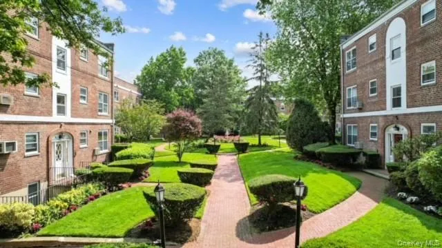 a view of a garden with a building in the background