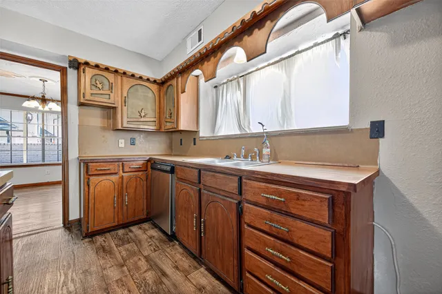 a kitchen with stainless steel appliances granite countertop a sink and cabinets