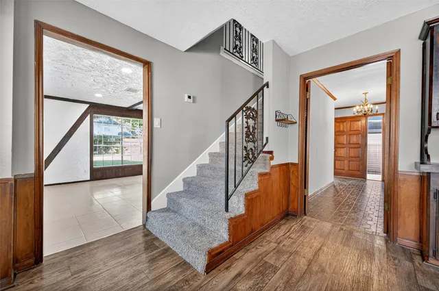 a view of entryway and hall with wooden floor