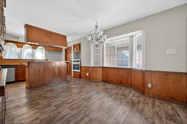 a view of wooden floor and windows in a room