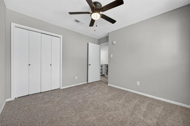 a bathroom with a granite countertop sink a toilet and a mirror