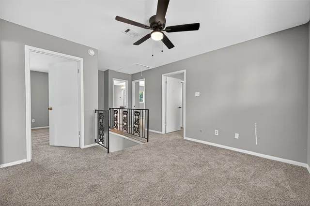 a view of room with a ceiling fan