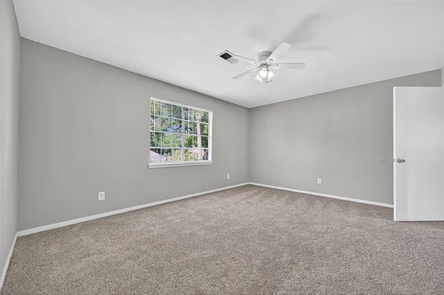 a view of an empty room with a fan