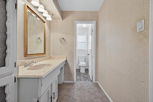 a bath tub sitting next to a white toilet