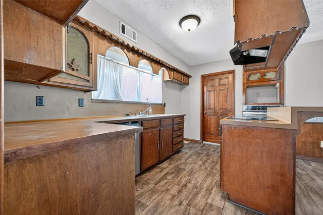 a kitchen with stainless steel appliances granite countertop a stove and a refrigerator