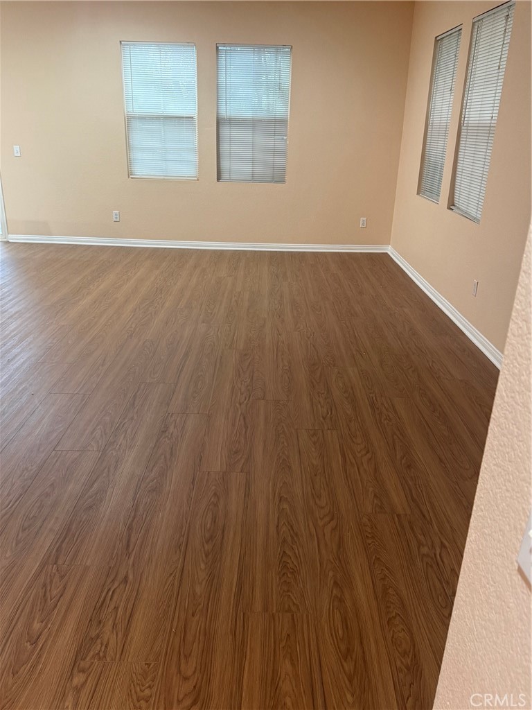 4420 Kristen Court Riverside, CA 92501 - Photo 7 of 39 LIVING ROOM/DINING ROOM AREA LAMINATE FLOORING FRESHLY PAINTED, MINI BLINDS