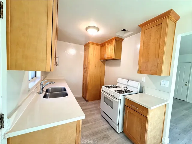 a kitchen that has a sink and a stove