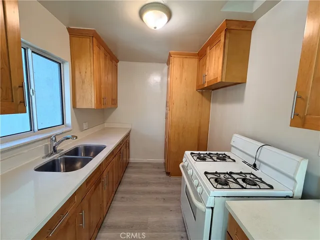 a kitchen that has a sink and a stove