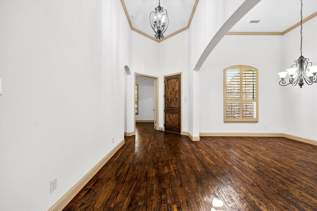 6814 Springwood Lane Garland, TX 75044 - Photo 9 of 35 a view of an empty room with wooden floor and a window