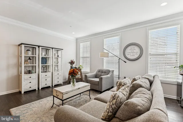a living room with furniture a clock and a window