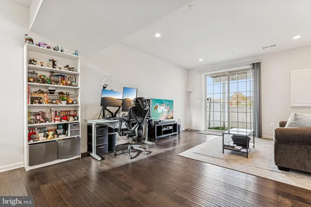 a view of a livingroom with workspace and a window