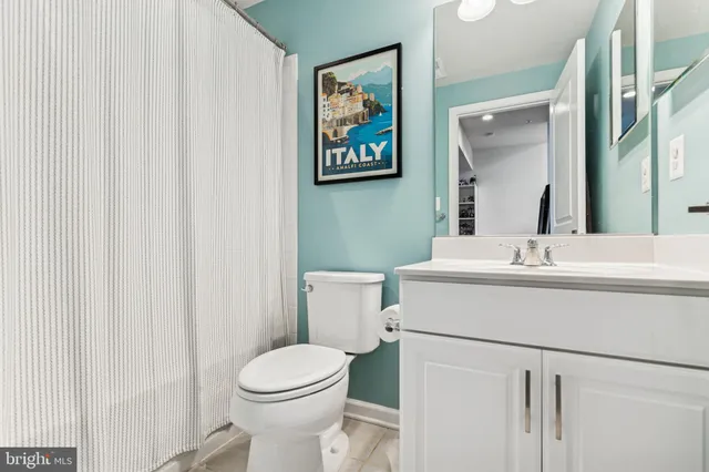 a bathroom with a sink mirror and toilet
