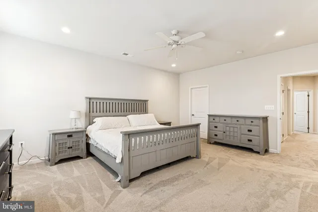 a spacious bedroom with a bed room and window