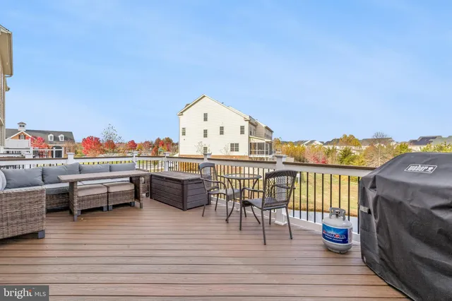 a view of a roof deck with furniture