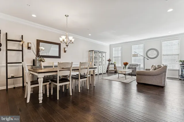 a living room with furniture dining table and wooden floor