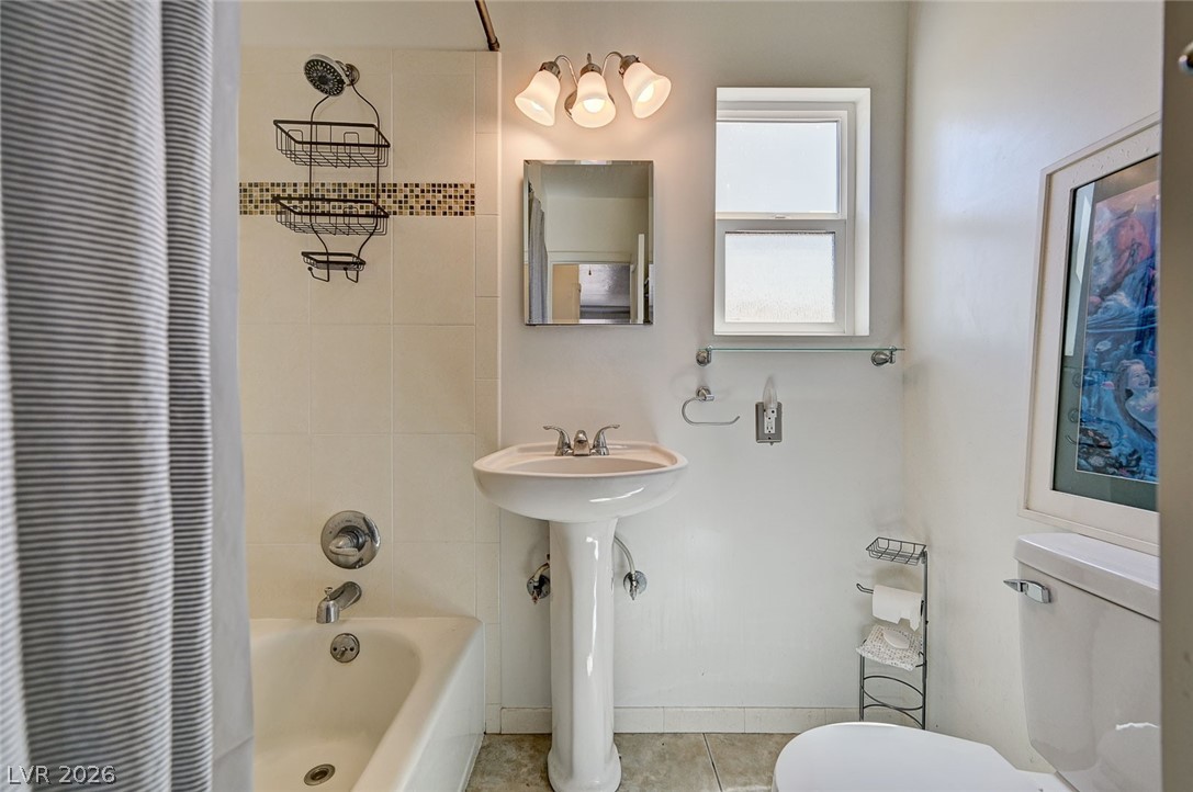 629 L Avenue Boulder City, NV 89005 - Photo 23 of 46 Bathroom featuring shower / tub combo with curtain and light tile patterned floors