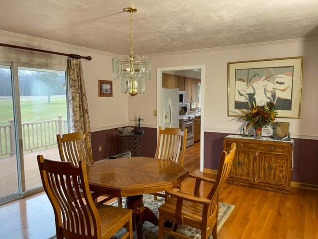 8243 Lamor Road Mercer, PA 16137 - Photo 7 of 25 a view of a dining room with furniture wooden floor and chandelier