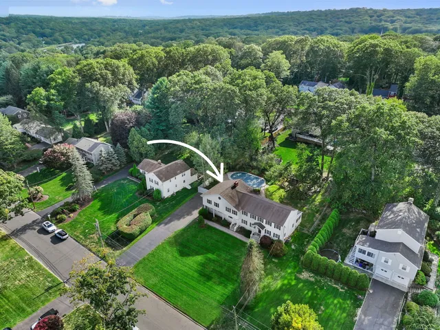 an aerial view of a house with a yard