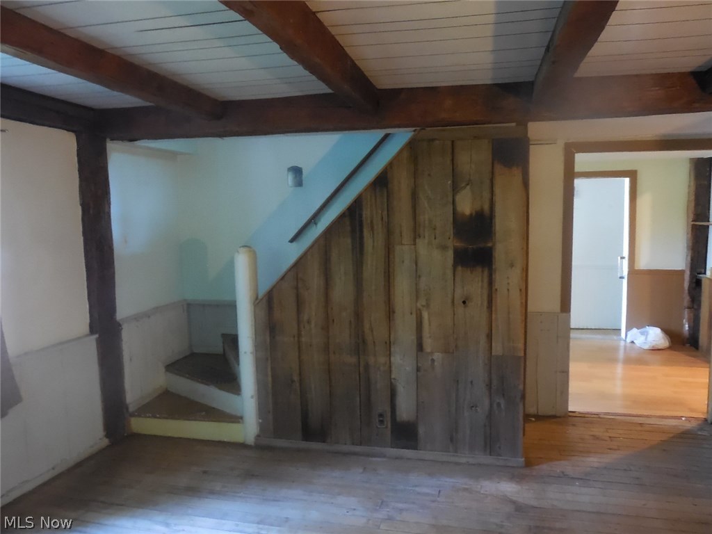 16875 Moseley Road Thompson, OH 44086 - Photo 7 of 19 part of living room with original beams and hardwood floors