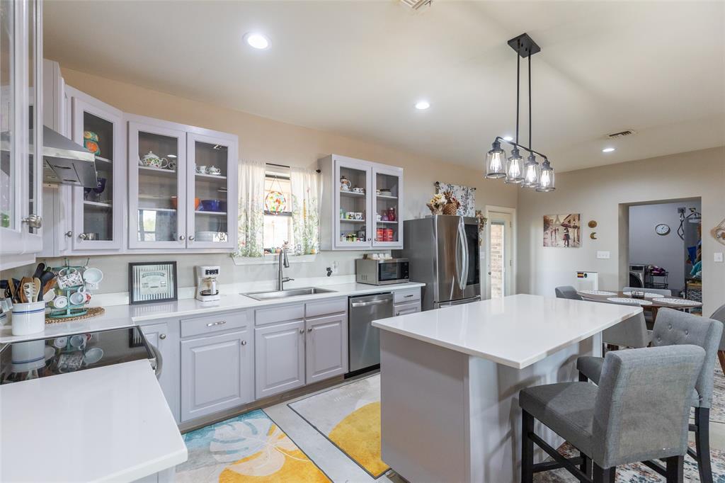 760 Wimberly Road Merkel, TX 79536 - Photo 14 of 35 Kitchen featuring a center island with countertop seating, recessed lighting, and a contemporary linear pendant light fixture