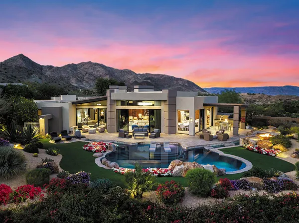 a view of a house with swimming pool and outdoor seating
