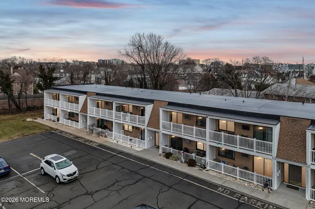 a front view of a house with windows yard and mountain view in back