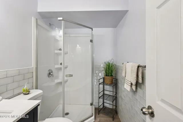 a bathroom with a shower and a sink