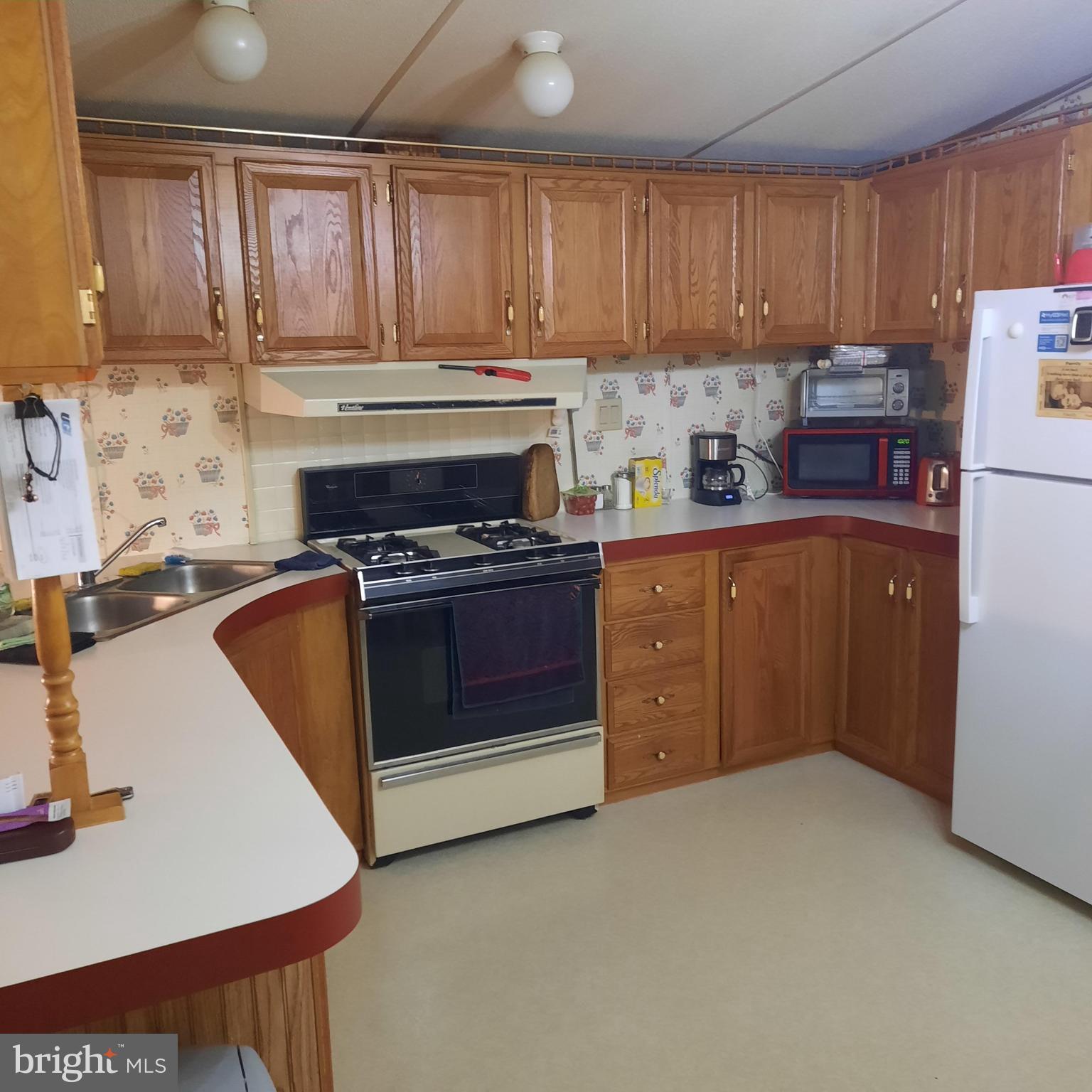 1047 Sage Avenue Reading, PA 19605 - Photo 3 of 8 a kitchen with stainless steel appliances granite countertop a stove refrigerator sink and cabinets