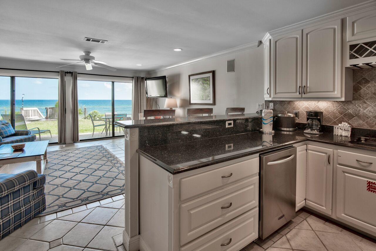214 Blue Mountain Road, Unit 111 Santa Rosa Beach, FL 32459 - Photo 4 of 13 a kitchen with a sink and cabinets